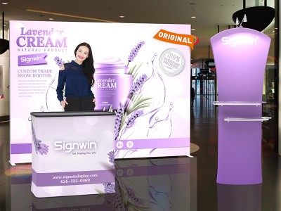 Custom 10x10ft Ultralit SEG Lightbox & Curved Top Banner Stand & Case to Podium Tension Fabric SEG Standard Booth 02